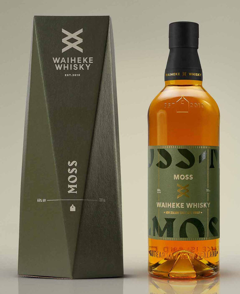 An image of a stunning bottle of Waiheke Whisky Moss Batch Peated Single Malt 700ml next to its handsome gift box