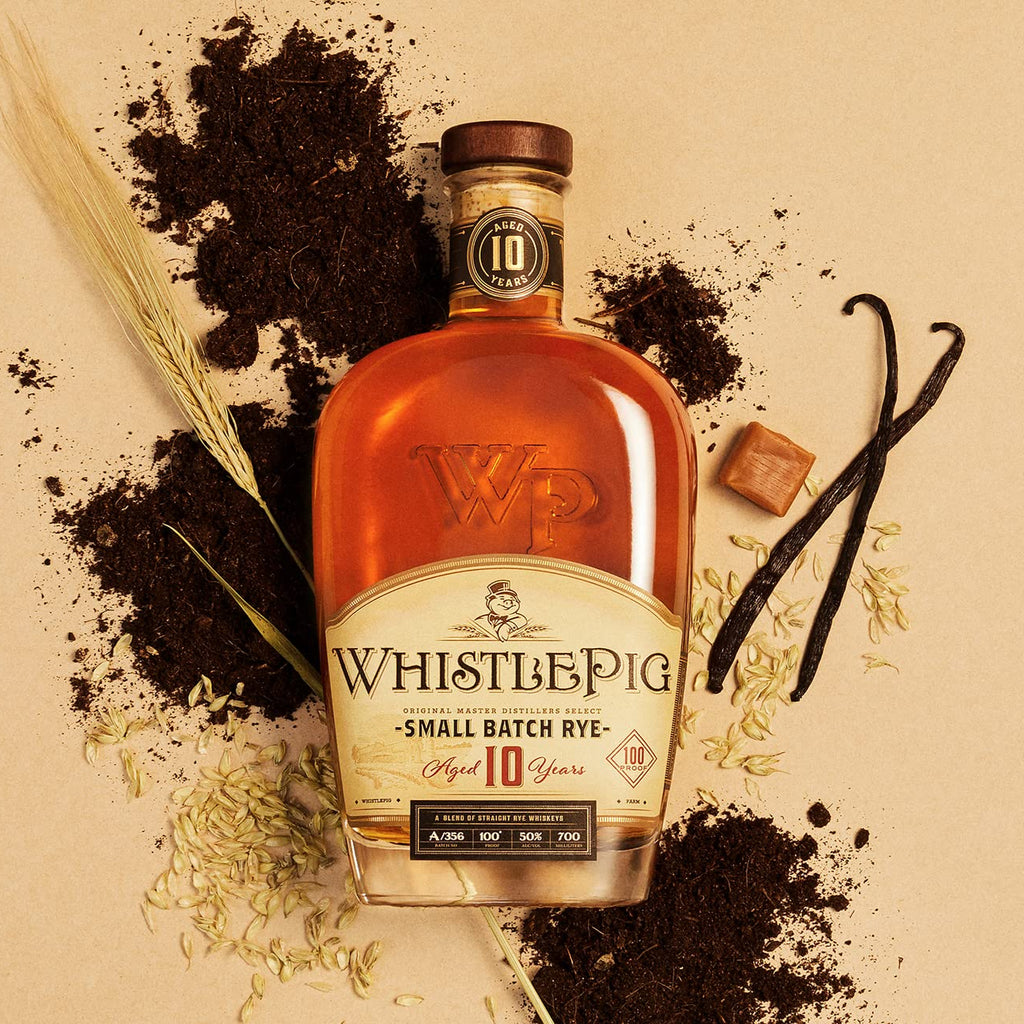WhistlePig Small Batch Rye bottle with vanilla beans and other elements on a beige background