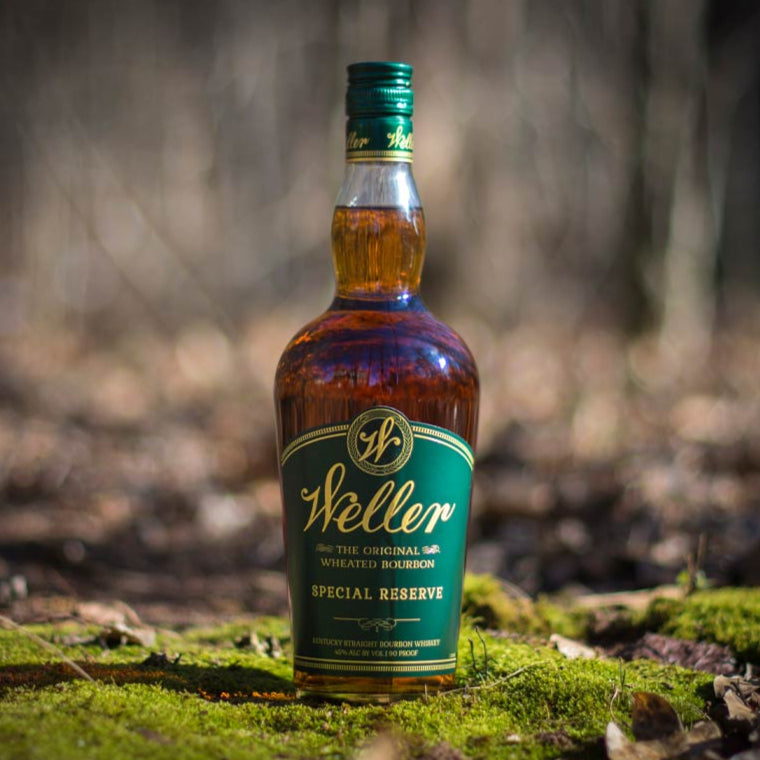 Load image into Gallery viewer, Bottle of Steller Special Reserve whiskey in a forest setting