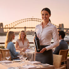 Load image into Gallery viewer, Waitress holding a Wirra Wirra RSW Shiraz  wine with Sydney Harbour Bridge in the background