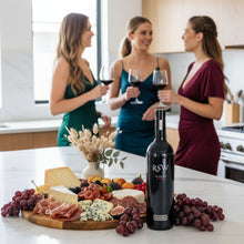 Load image into Gallery viewer, Three women in a kitchen enjoying wine and a charcuterie board with a bottle of Wirra-Wirra-RSW-Shiraz wine.