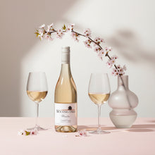 Load image into Gallery viewer, Wooing Tree Blondie Rose wine bottle with two glasses and a vase on a light pink background