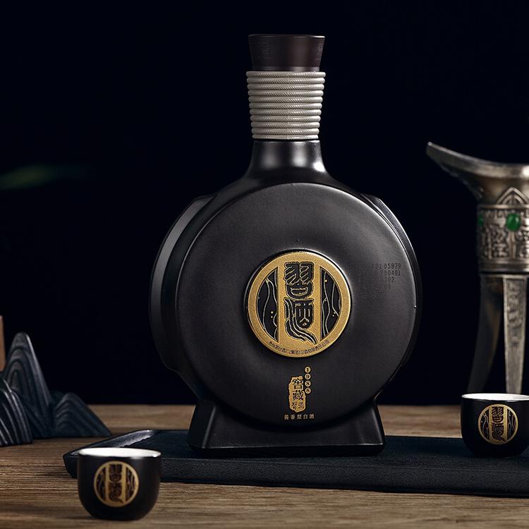Load image into Gallery viewer, Xijiu Jiao Cang 1988 Baijiu ceramic bottle with gold emblem on a dark background