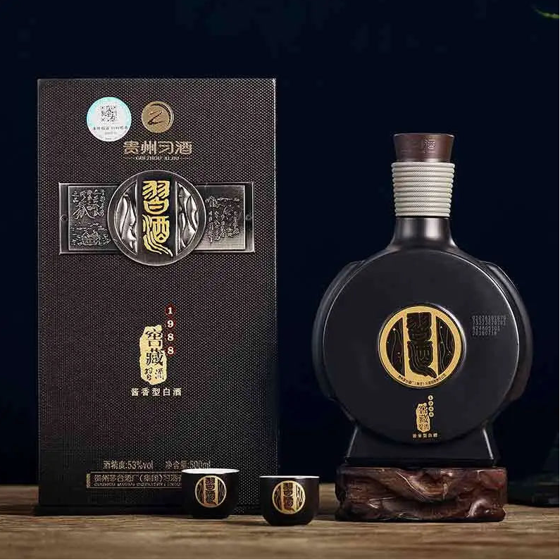 Load image into Gallery viewer, Xijiu Jiao Cang 1988 Baijiu bottle next to its gift box packaging, a traditional Chinese liquor on a wooden surface with a dark background
