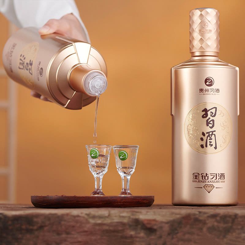 Load image into Gallery viewer, Bottle of Xijiu Jin Zuan Baijiu 500ml being poured into two glasses with a wooden tray.