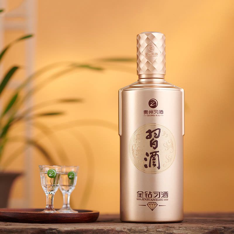 Load image into Gallery viewer, Gold bottle of Xijiu Jin Zuan Baijiu 500ml  with two glasses on a wooden tray against a warm background