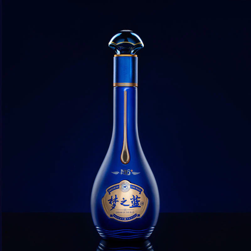 Blue bottle with gold accents on a black background