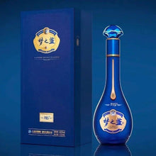 Load image into Gallery viewer, Blue bottle and box with brand logo on a blue background
