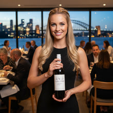 Load image into Gallery viewer, Woman holding a Yarra-Yering-Underhill-Shiraz bottle in a restaurant with a cityscape view