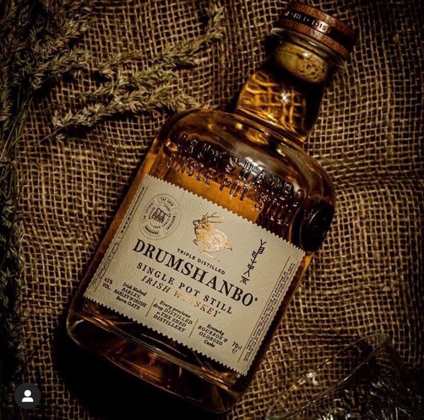 Load image into Gallery viewer, Drumshanbo whiskey bottle on a textured surface