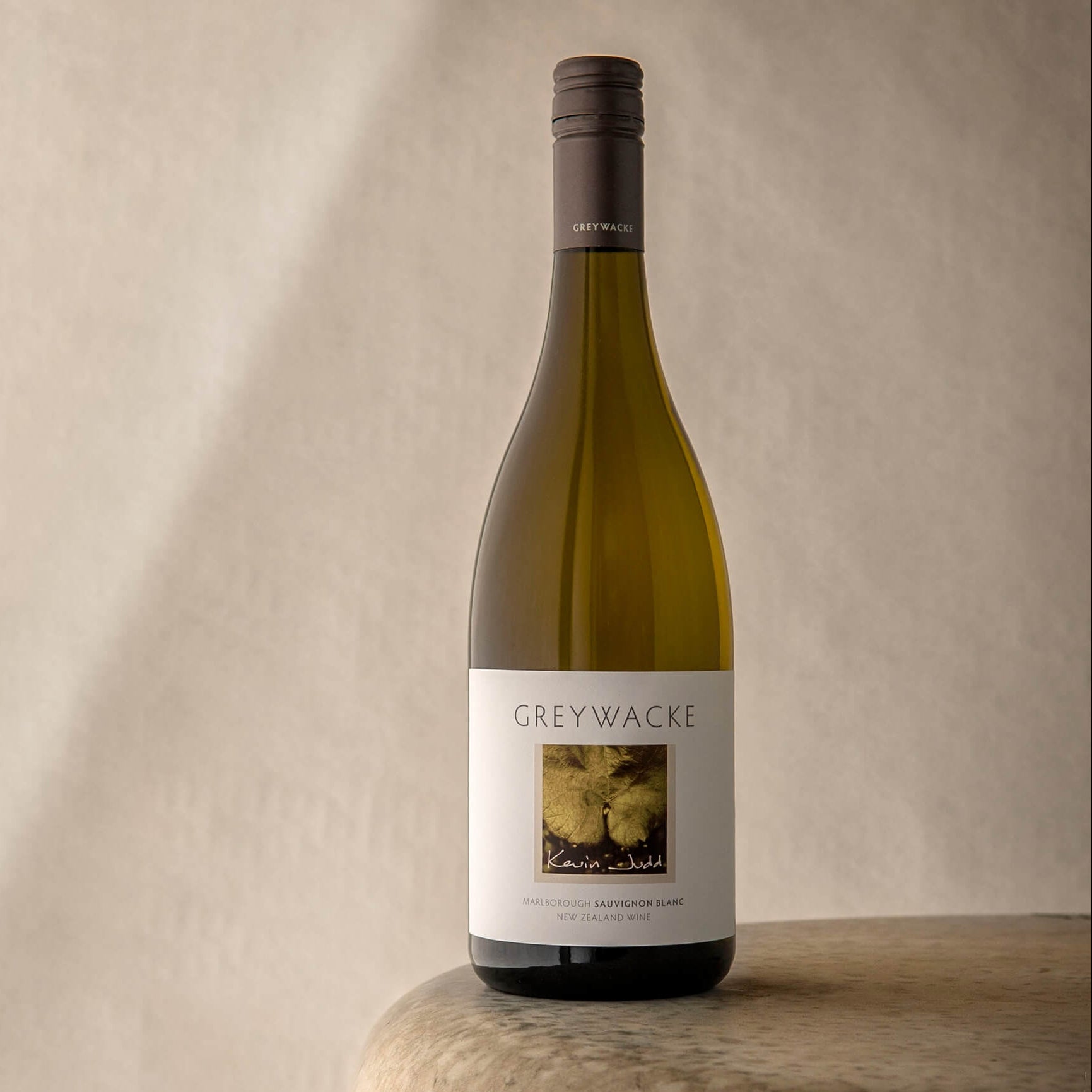 Load image into Gallery viewer, Wine bottle labeled 'Greywacke' on a wooden surface with a neutral background