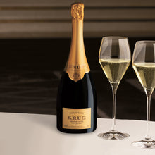 Load image into Gallery viewer, Bottle of Krug champagne with two filled glasses on a dark background