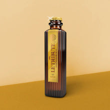 Load image into Gallery viewer, Bottle of Le Tribute Ginger Beer on a two-tone yellow background