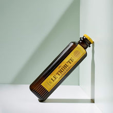 Load image into Gallery viewer, Bottle of Le Tribute Ginger Beer on a white surface with light green background