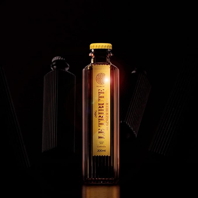 Load image into Gallery viewer, Bottle of Le Tribute ginger beer with a dark background