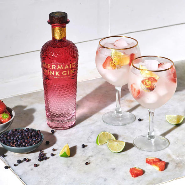 Load image into Gallery viewer, Mermaid Pink Gin bottle with two glasses of pink cocktail on a marble surface.