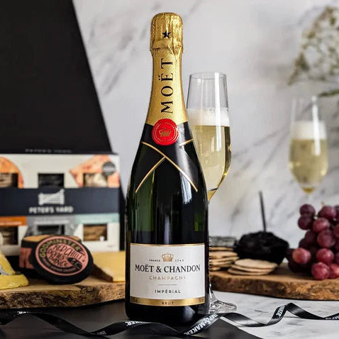 Load image into Gallery viewer, Moét é Chandon champagne bottle with a glass of champagne on a table with snacks.