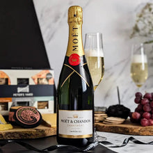 Load image into Gallery viewer, Moét é Chandon champagne bottle with a glass of champagne on a table with snacks.