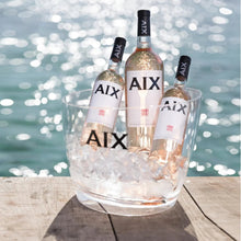 Load image into Gallery viewer, Three bottles of AIX wine in a glass ice bucket by a waterfront.