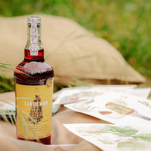 Load image into Gallery viewer, Bottle of Sandeman brand wine on a table outdoors with a blurred background