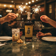 Load image into Gallery viewer, Two people holding sparklers with a bottle of Sandeman 20-year-old Port and glasses on a table.