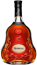 Load image into Gallery viewer, A bottle of Hennessy XO Cognac with a clear label displaying the brand name and the type of cognac. The bottle is tinted with a red hue, emphasizing the color of the cognac.